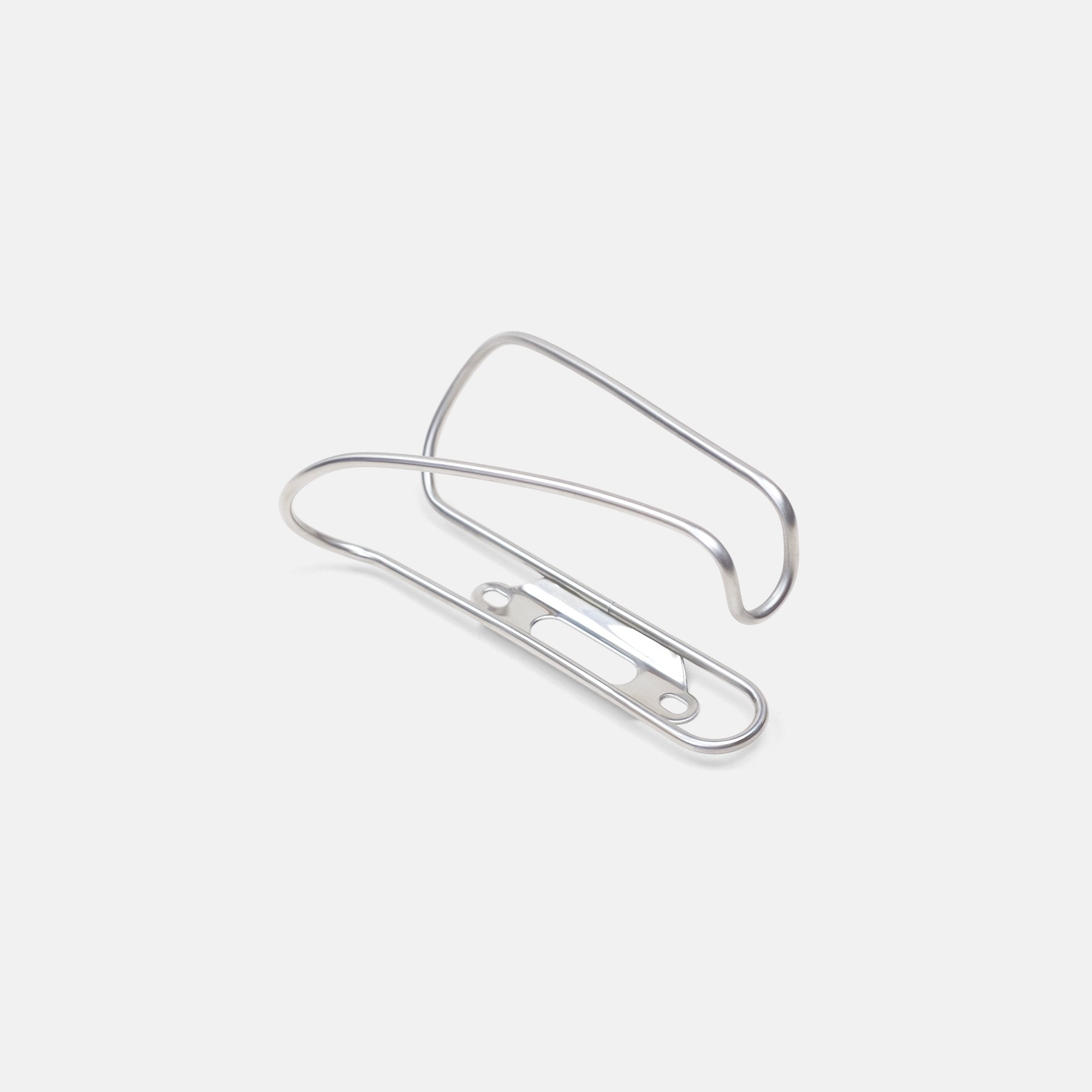 Minimalist stainless steel durable bicycle bottle cage with lightweight wire design, shot in a studio setting.