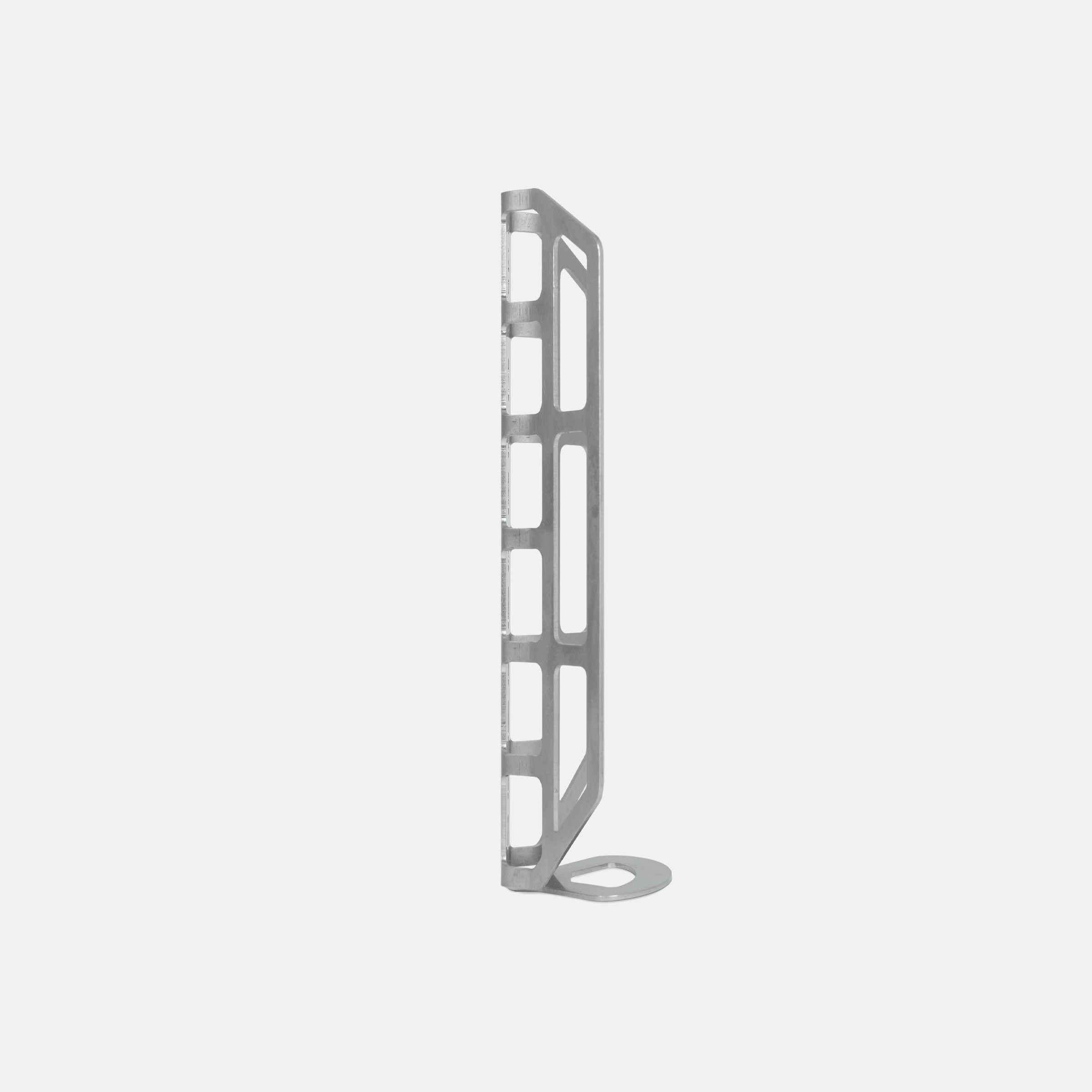 Side view of a stainless steel cargo cage in a studio setting.
