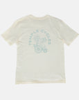 Back of Clara unisex, organic cotton tee in cream and green, studio setting.