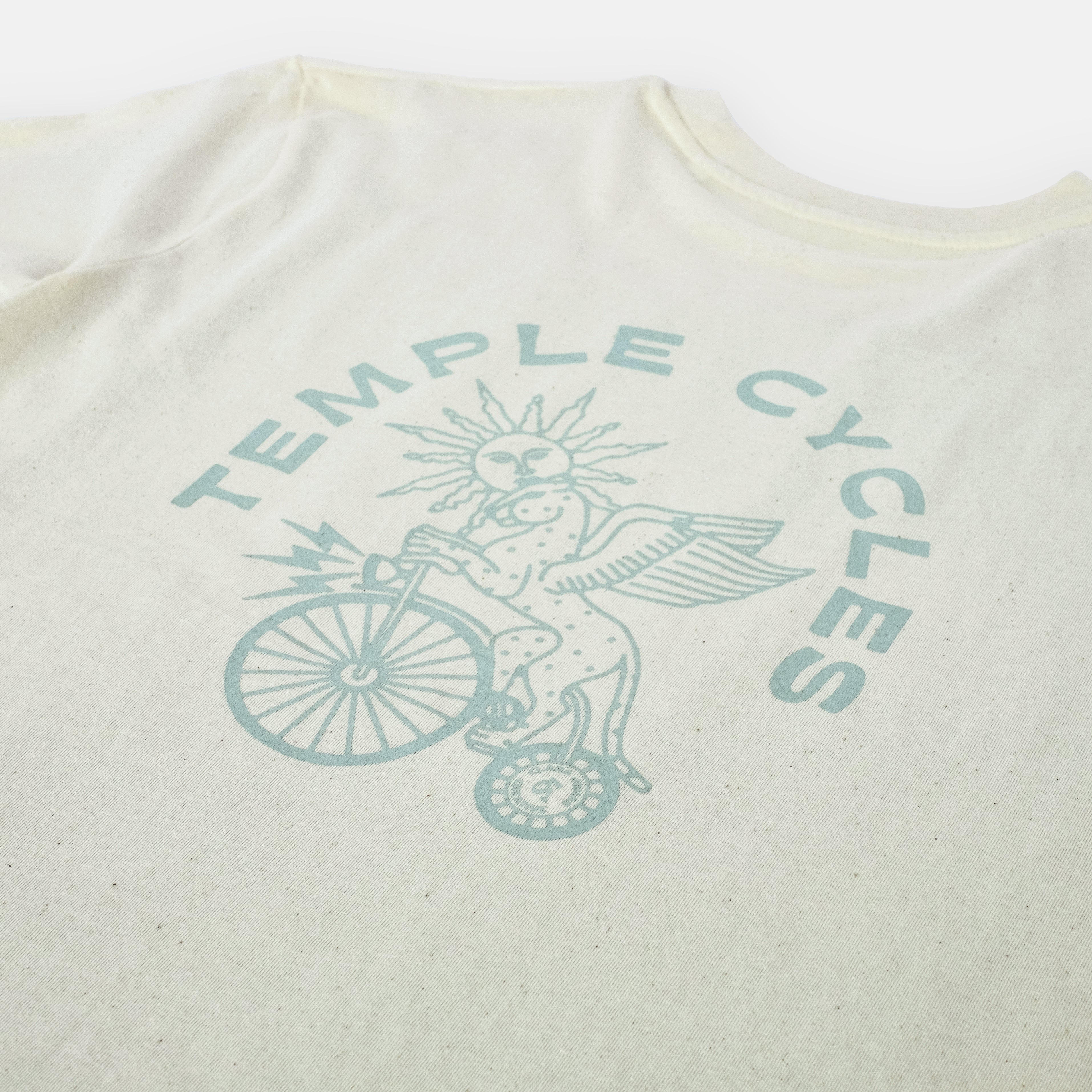 Unisex Clara x Temple Cycles graphic on sustainable, super soft T Shirt, studio setting.