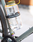 Large Nalgene bottle secured to a Temple Cycles bike frame using a Voile strap.