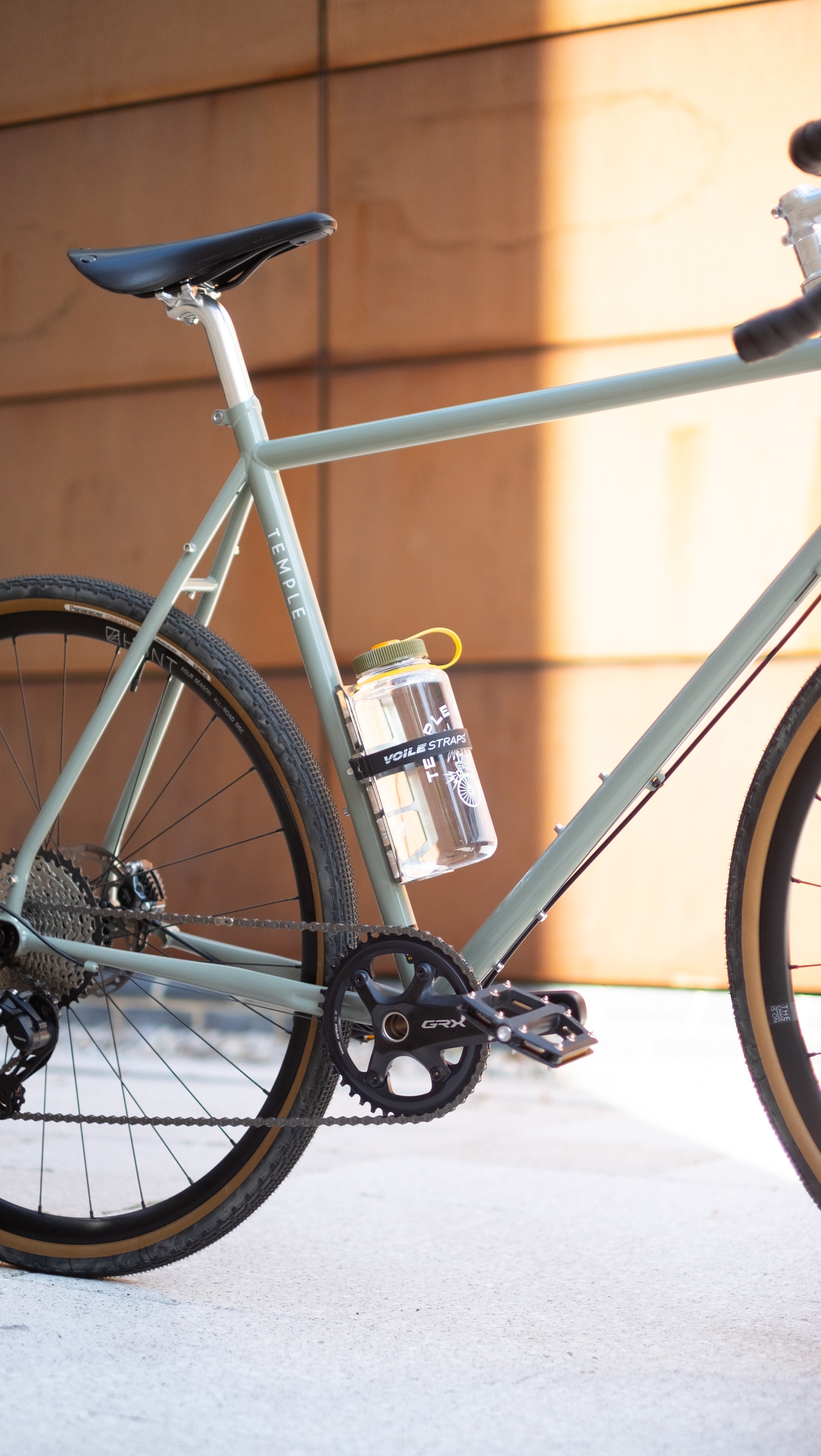 Large Nalgene water bottle secured to a steel framed Temple Cycles bike using a Voile strap.