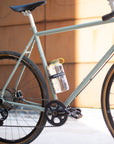 Large Nalgene water bottle secured to a steel framed Temple Cycles bike using a Voile strap.