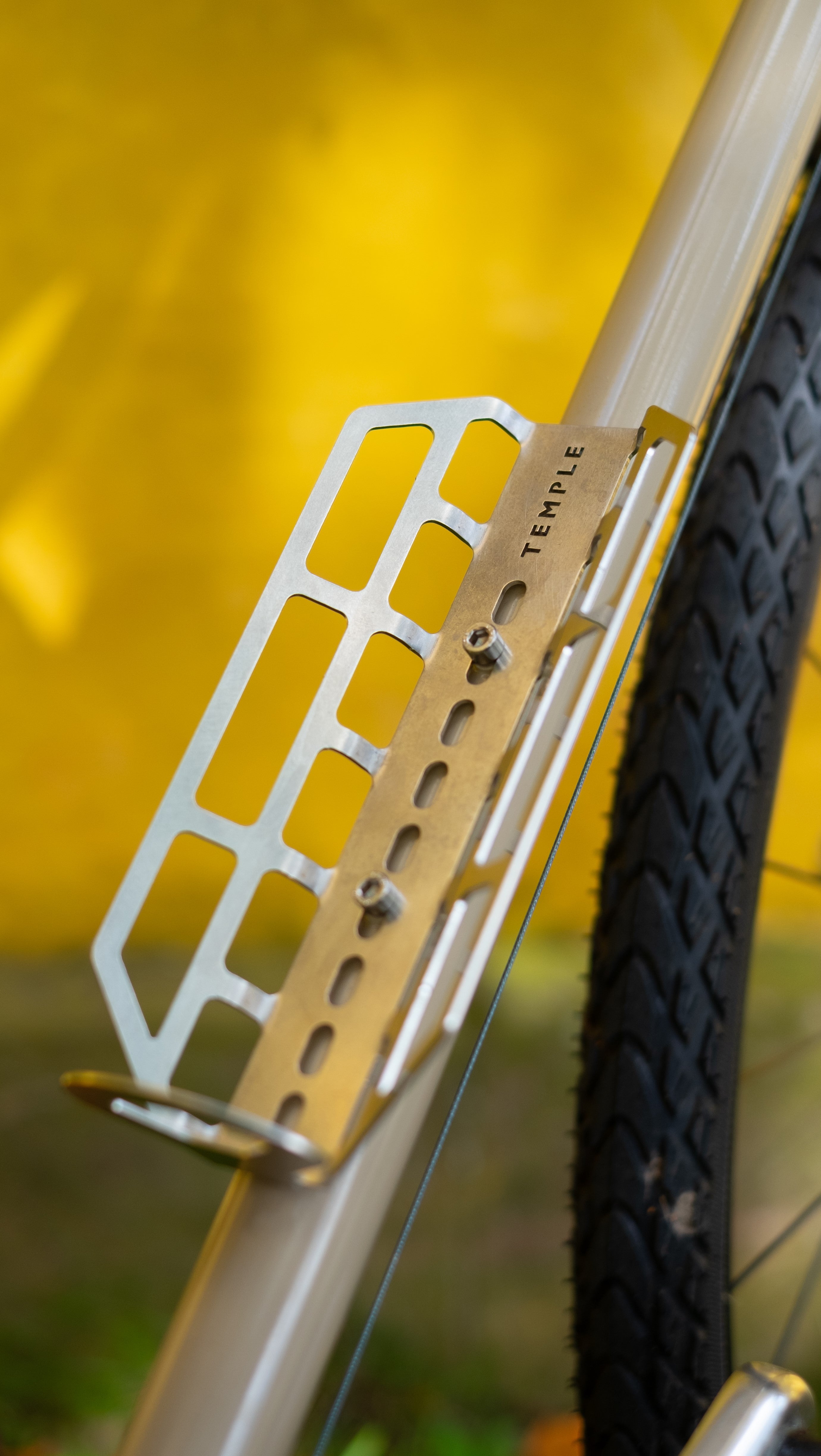 Close up shot of a stainless steel cargo cage mounted on a steel framed Temple Cycles bike.