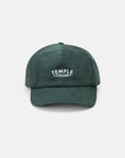 Temple branded dark green corduroy cap, studio setting.