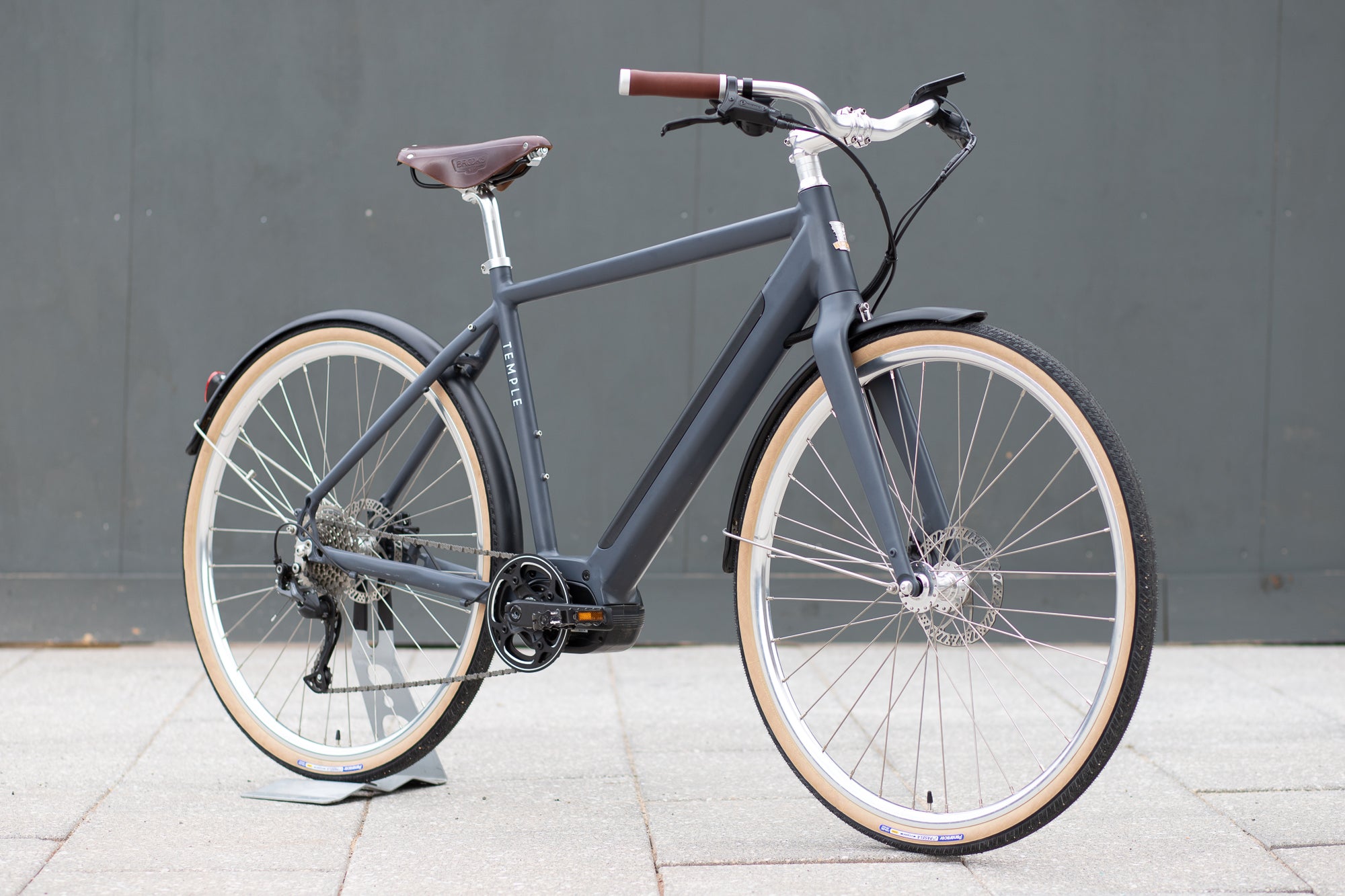 Classic black electric bike, urban setting.