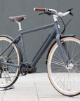 Classic black electric bike, urban setting.