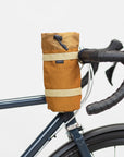 Open, burnt orange cycling snack bag side view, studio setting.