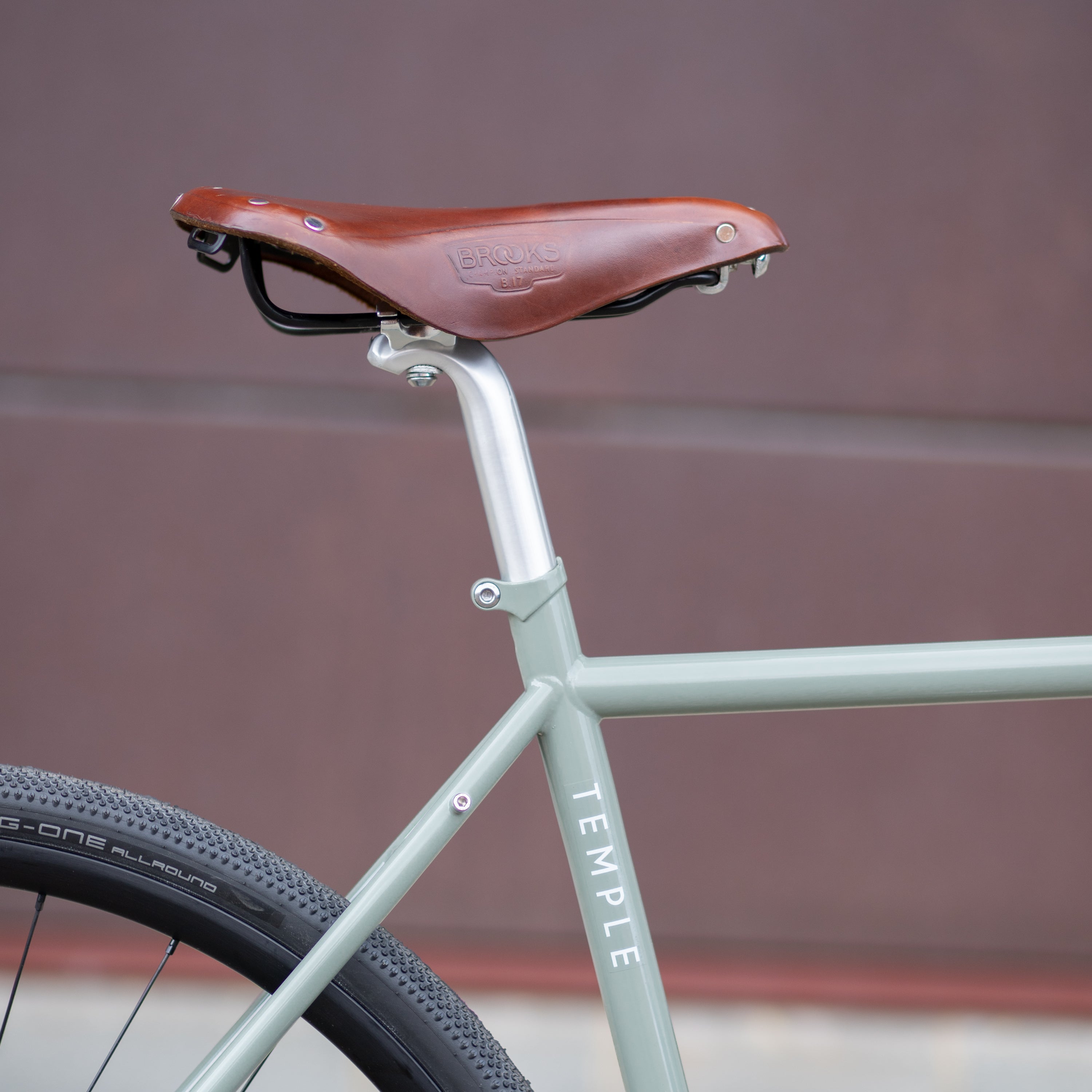 Brooks leather saddle on green steel framed gravel bike.