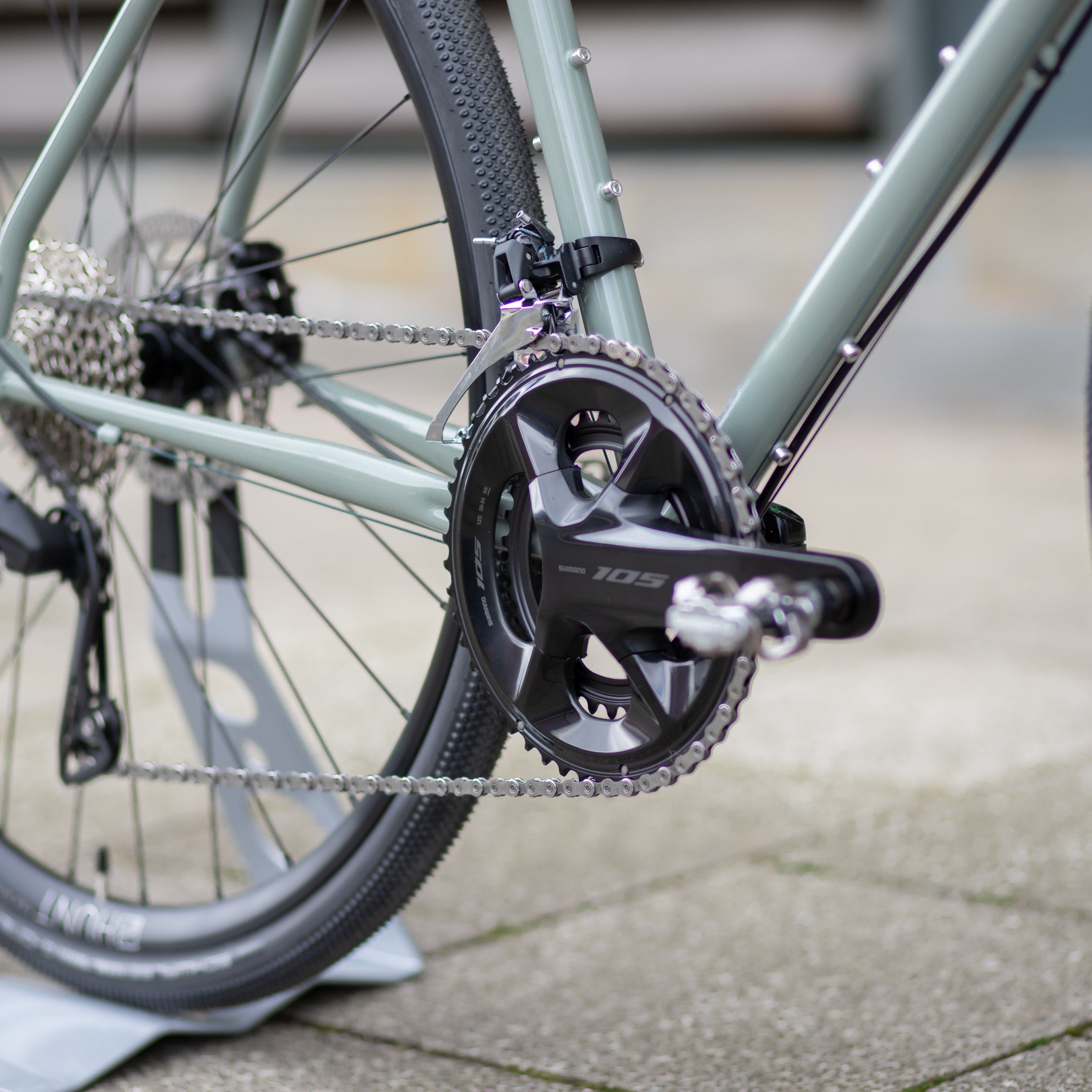 Shimano 12-speed groupset chain on a lightweight steel framed adventure bike.