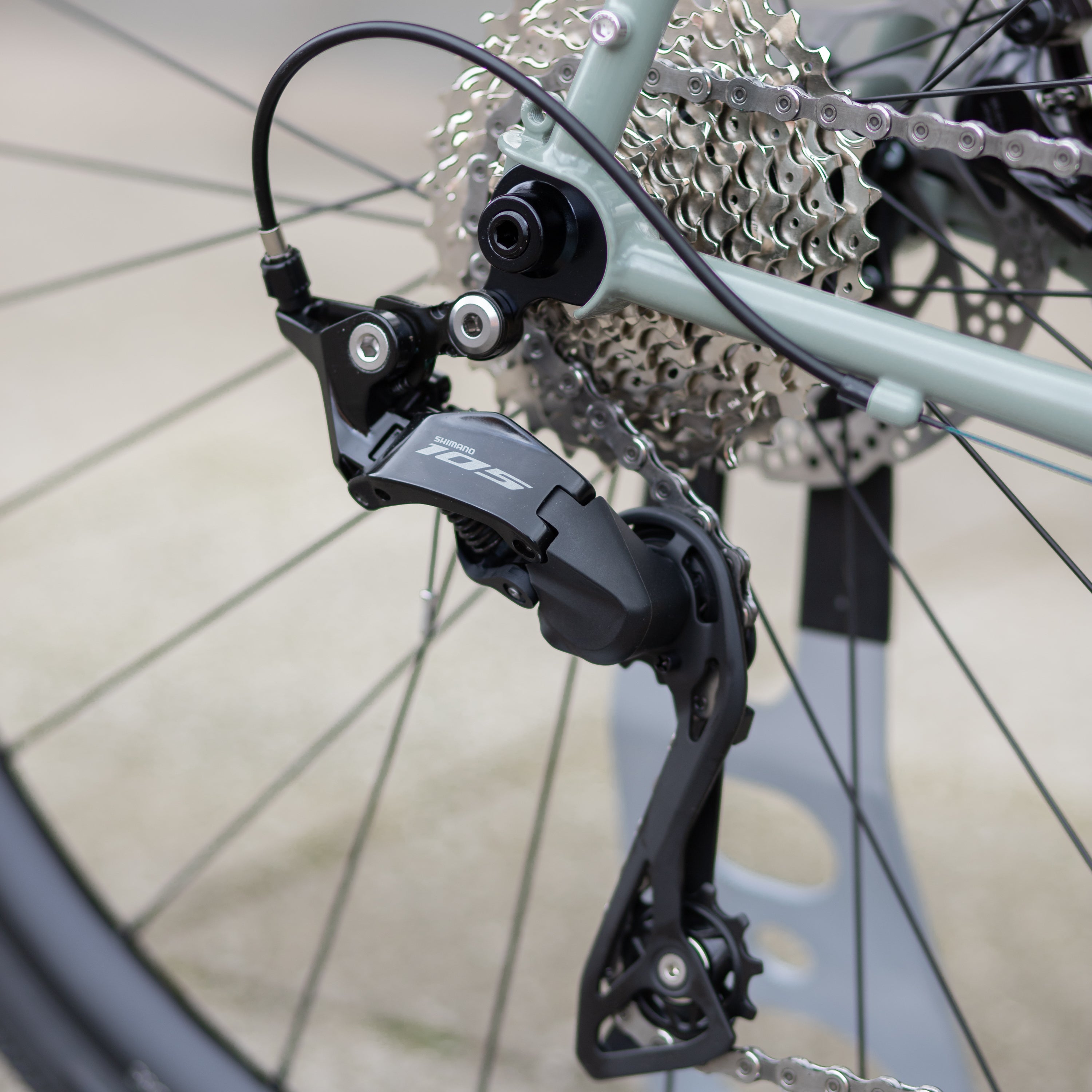 Shimano 105 brake callipers on the back wheel of an adventure touring bike.