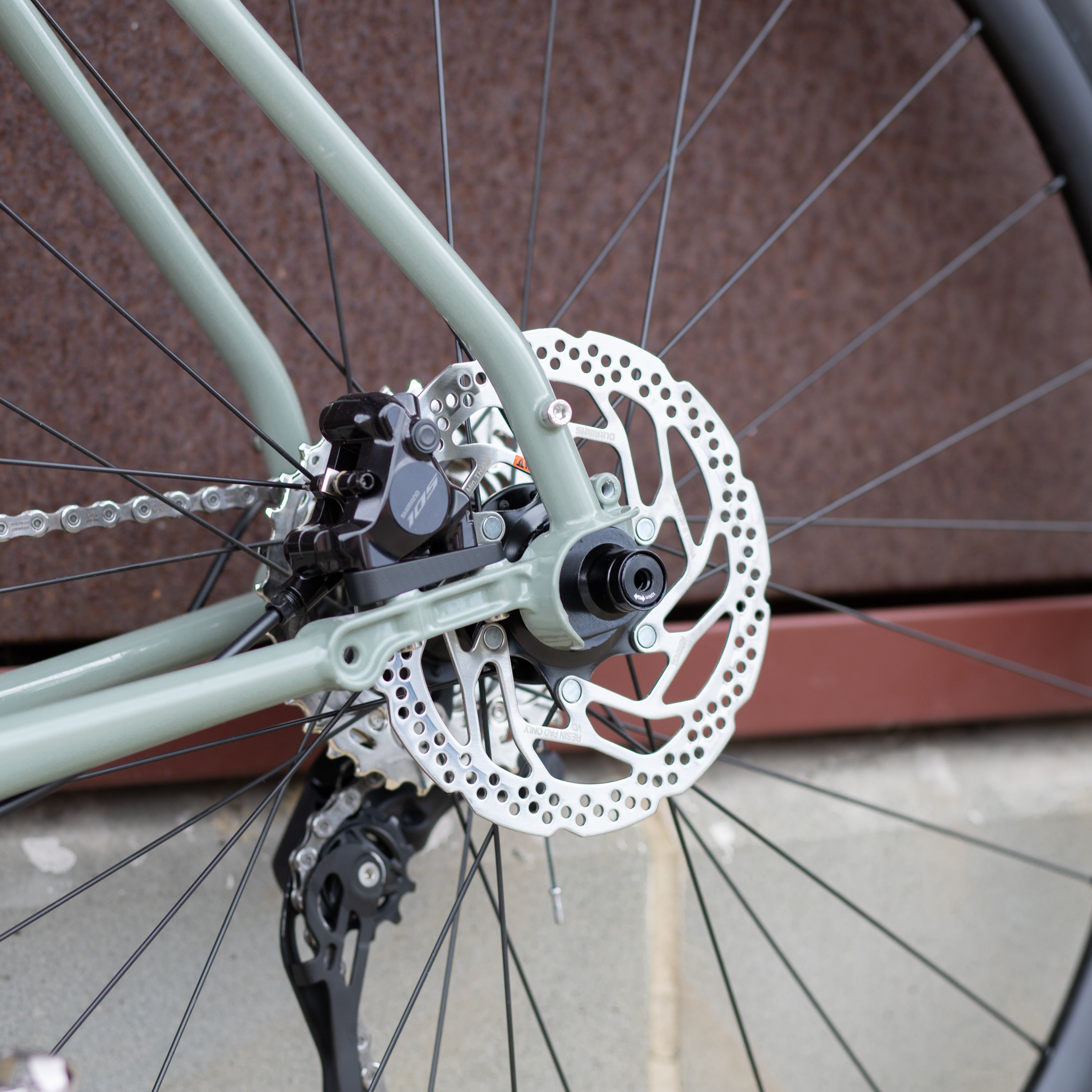 Shimano 105 crankset on the back wheel of a lightweight adventure touring bike.