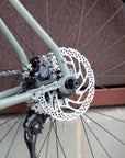 Shimano 105 crankset on the back wheel of a lightweight adventure touring bike.