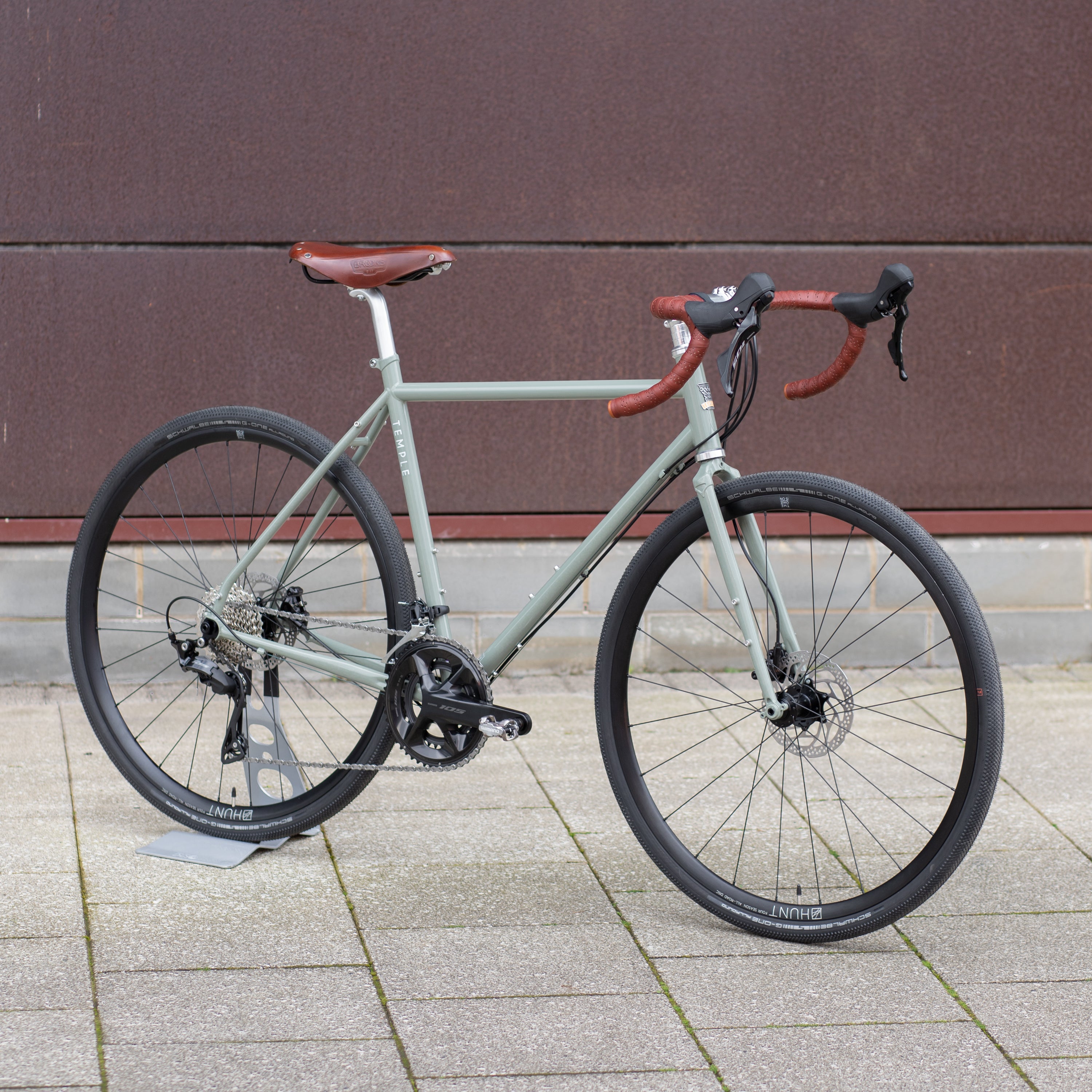 Steel framed adventure bike in an urban setting, green colour.