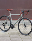 Steel framed adventure bike in an urban setting, green colour.
