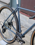 Back wheel hand built by Hunt | Tubeless Panaracer tyre on blue adventure bike in a city setting.