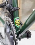 Reynolds 853 steel frame emblem and Shimano chainset on a dark green road bike.