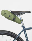 Waterproof, cycling saddle bag in green, studio setting.