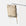 Waterproof beige roll-top canvas pannier backpack hanging on a pole in a studio setting.