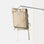 Waterproof beige roll-top canvas pannier backpack hanging on a pole in a studio setting.