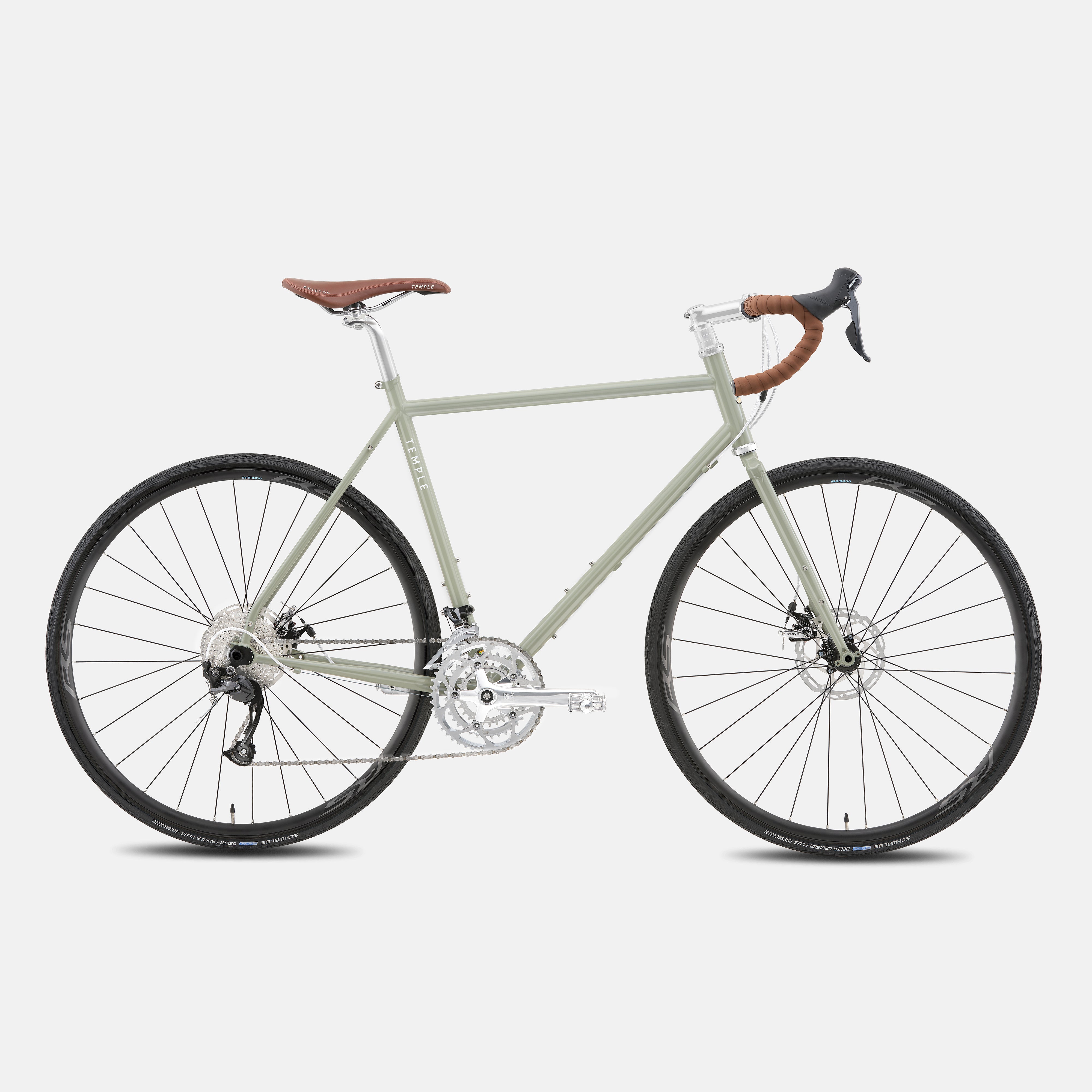 Green touring adventure bike with a lightweight steel frame, studio setting.
