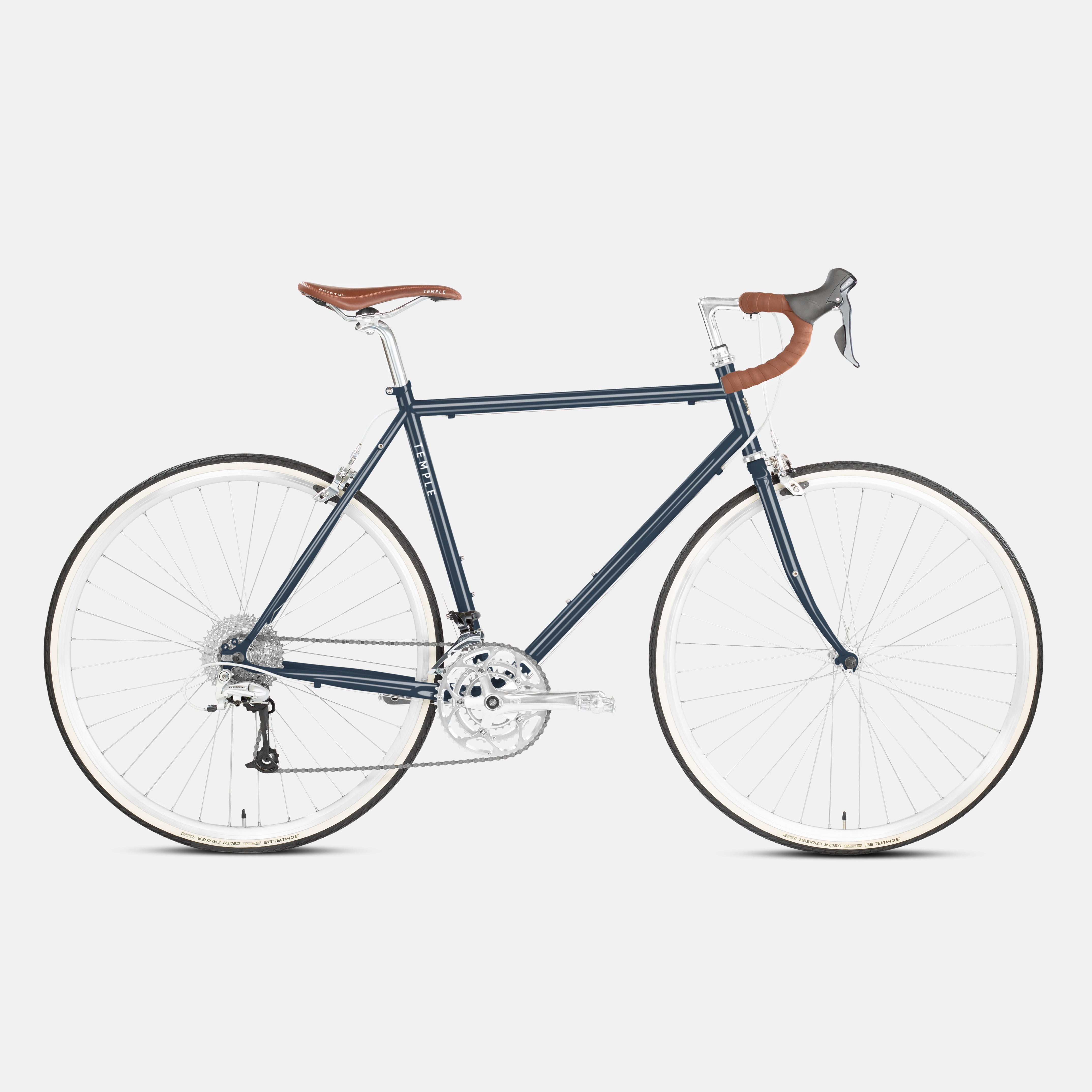 Green, steel-framed bikepacking  bike in a studio setting.