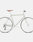 Steel commuter bike in light green, studio setting.