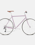 Pink classic commuter bike with a lightweight steel frame in a studio setting.