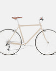 Classic lightweight hybrid bike in beige, studio setting.