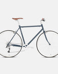 Blue daily commuting bike with a steel frame, studio setting.