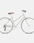 Comfortable step through steel bike in green, studio setting.