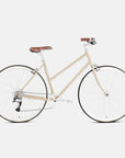 Lightweight commuting bike in beige, studio setting.