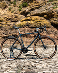 Bicycle on a rocky surface with a rocky cliff background