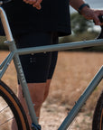 Person holding a bicycle with 'Temple' branding in an outdoor setting