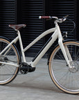 Step Through electric cream bike, urban setting.