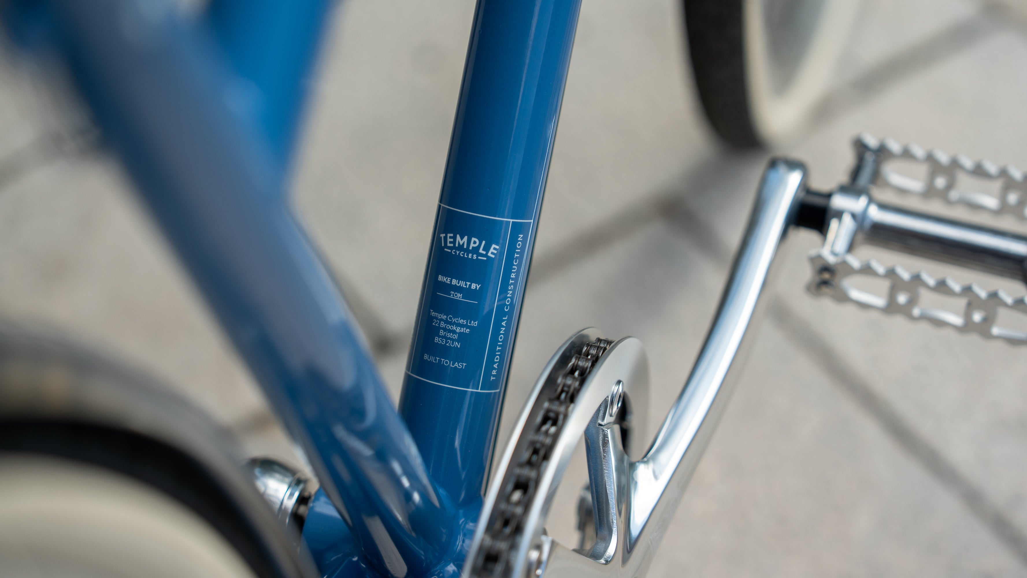 Close up of a Temple Cycles branded decal on a steel framed blue bike.