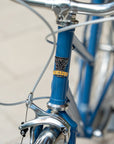 Front shot of Temple Cycles badge on a steel framed blue bike.