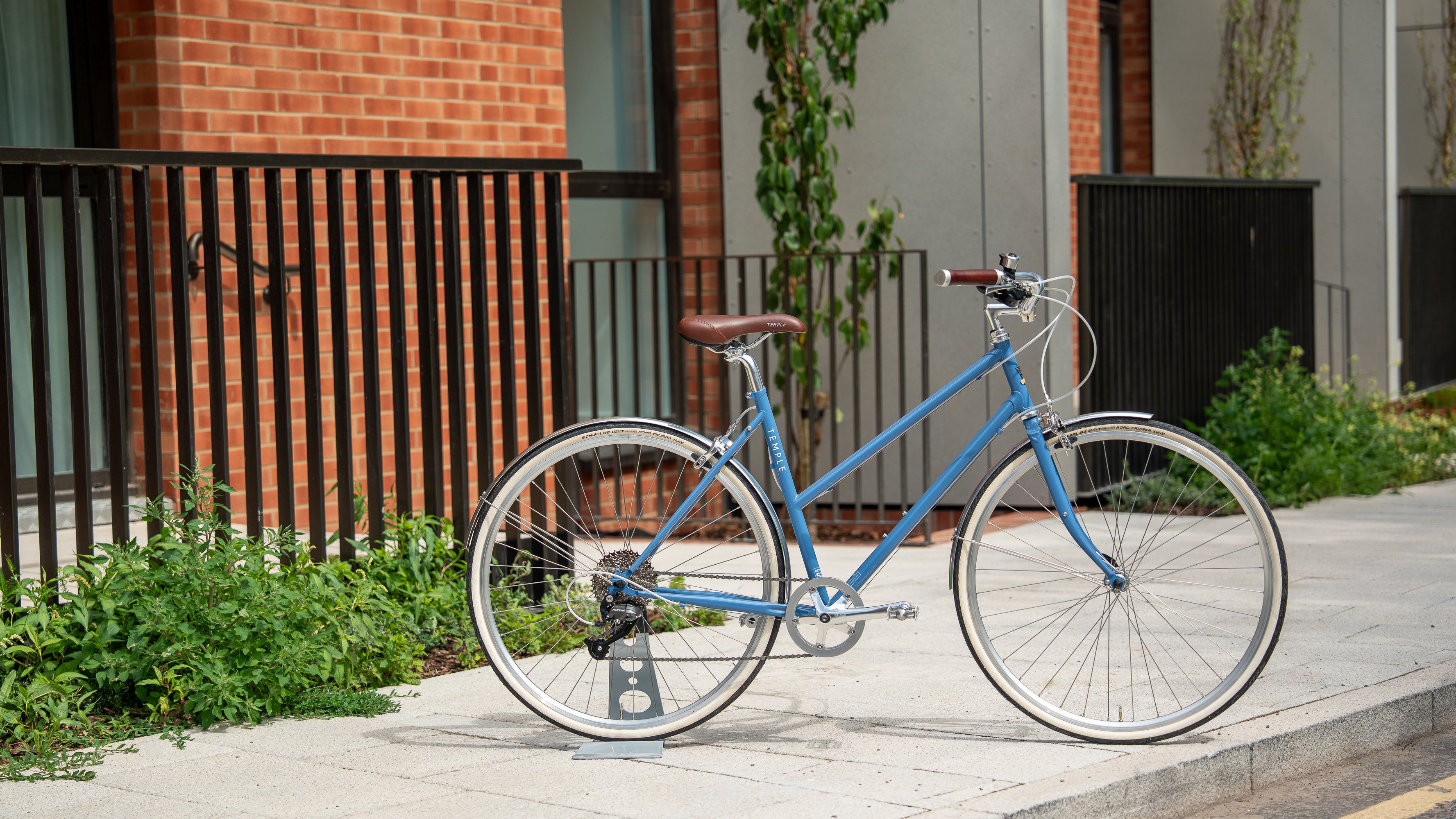 Sky Blue Reynolds steel frame bike shot in an urban setting.