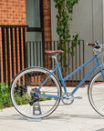 Sky Blue Reynolds steel frame bike shot in an urban setting.