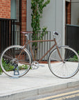 Woodland Brown Classic Lightweight bike in an urban setting.