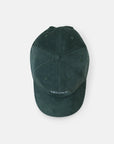 Top view of sustainable, super comfy green corduroy hat, studio setting.