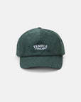 Temple branded dark green corduroy cap, studio setting.