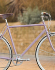 Classic all-rounder pink town bike, rural setting.