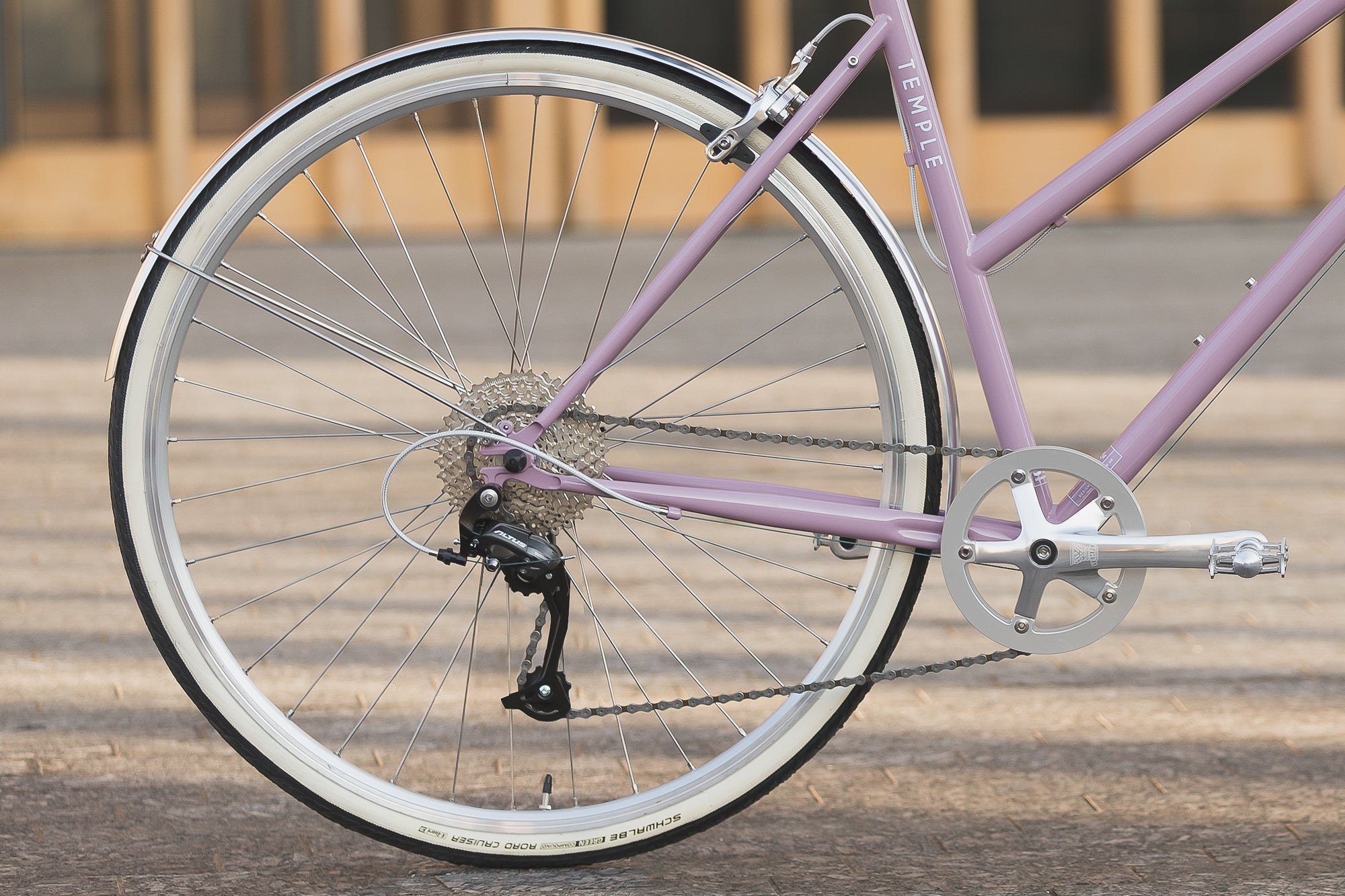 Rear wheel and hill-climbing Shimano gears on a lightweight Step Through daily bicycle.