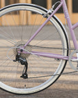 Rear wheel and hill-climbing Shimano gears on a lightweight Step Through daily bicycle.