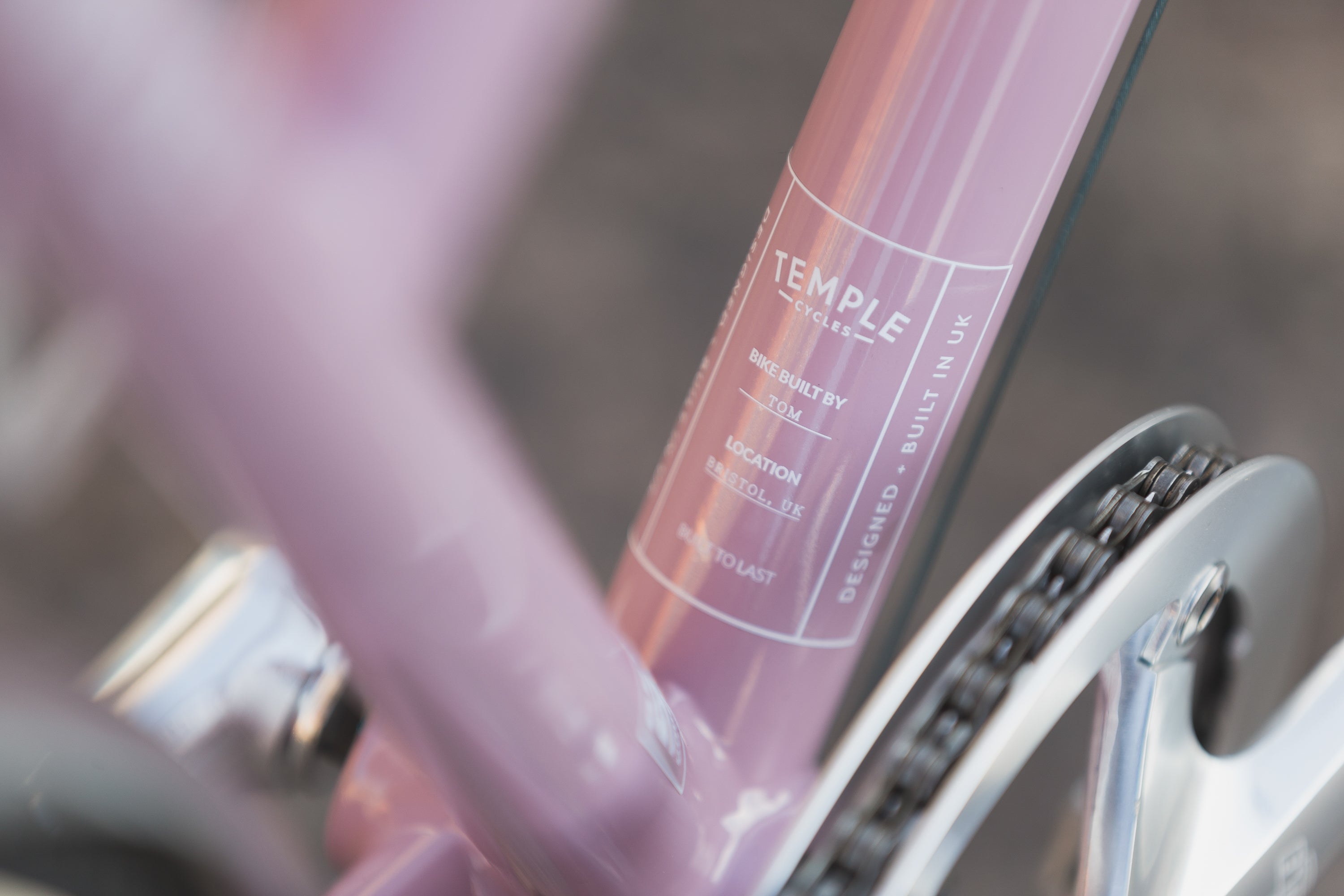 Temple Cycles specification detail on pink steel Step Through Lightweight bike.