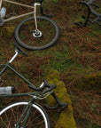 Birds-eye view of three lightweight road bikes in a country-rural setting.