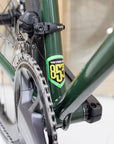 Reynolds 853 steel frame emblem on a dark green versatile road bike.