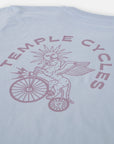 Clara Jonas X Temple Cycles unique graphic on light blue T Shirt, studio setting. 