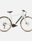 Versatile classic cream electric bike in a studio setting.